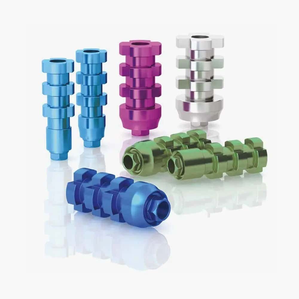 Multicoloured dental implant abutments used in dental restoration procedures.